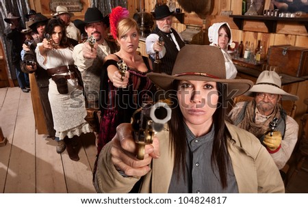 Armed saloon customers with pistols in old western scene