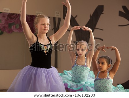 Three female dance students of different ages practicing together