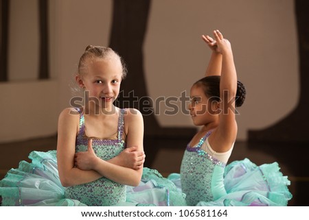Pretty little ballet students in performance dresses