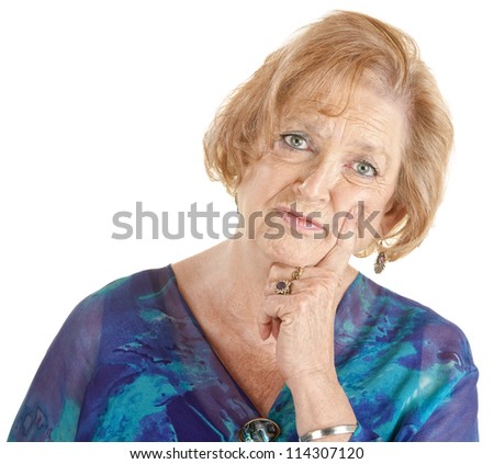Serious Caucasian lady in blue with finger on cheek