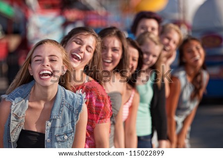 Group of eight girls in a row laughing