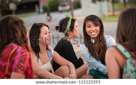 Diverse group of happy teenage girls sitting and talking