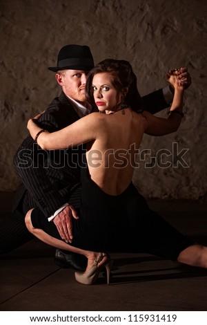 1920s style male tango dancer holding his dance partner