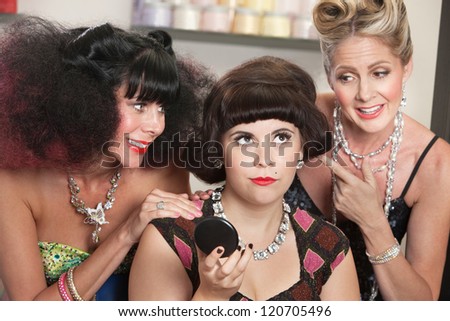 Annoyed pretty woman with older ladies in beauty salon