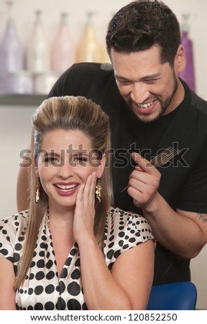 Cute Arab hair stylist admiring woman\'s haircut