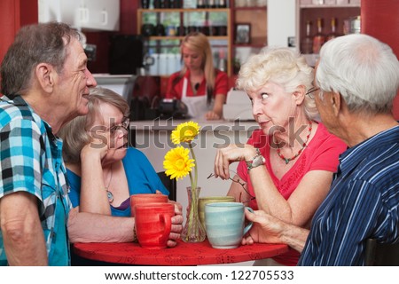 Concerned woman conversing with friends in bistro