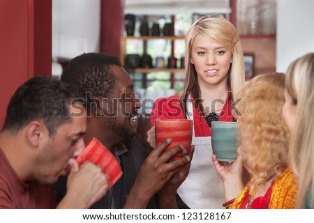 Diverse group of customers with mugs and restaurant attendant