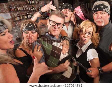 Nerd husband and wife being cool with biker gang in bar
