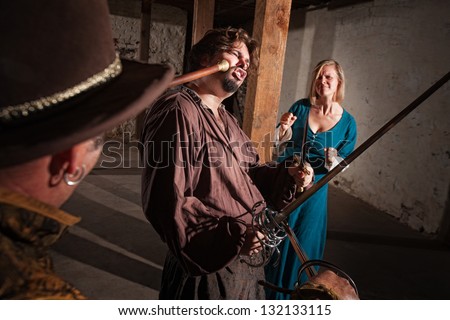 Sympathetic lady watches man get hit by mace in medieval battle