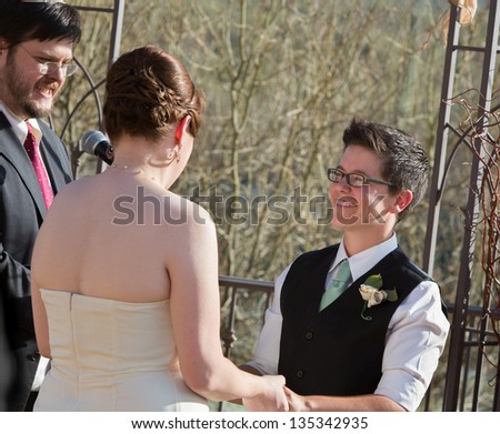 Smiling woman with partner in civil union ceremony