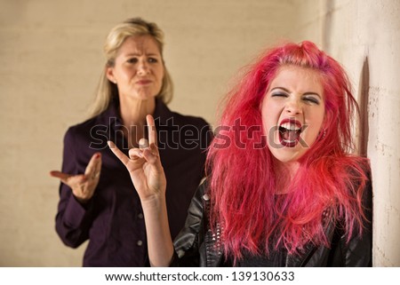 Angry parent with loud teenager with pink hair
