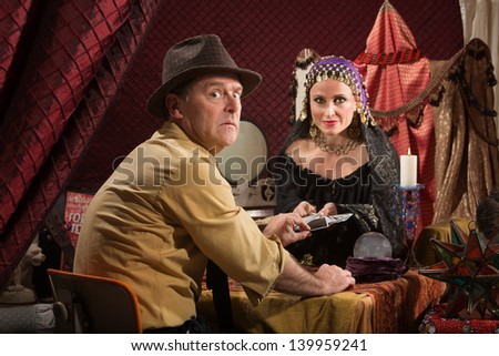 Man with fortune teller worried about bad luck