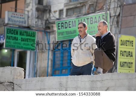 ANKARA, TURKEY on APRIL 15: Men having a conversation on a city street on April 15, 2012 in Ankara, Turkey prior to Anzac Day.  Turkish men in cities and villages gather each day to talk.