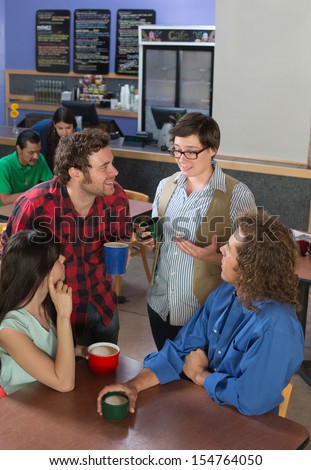 Interested group of people listening to woman in restaurant