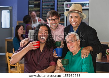 Diverse group of men celebrating in coffee house