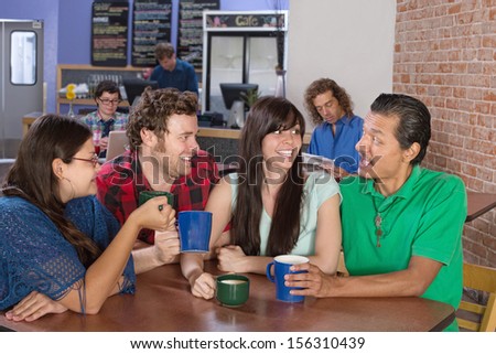 Cheerful group of people socializing in a coffee house