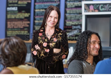 Beautiful mature woman standing in coffee house