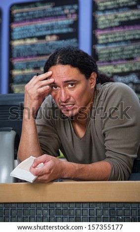 Stressed out Native American restaurant owner at counter