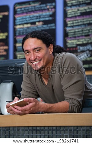 Handsome Native American restaurant owner at counter