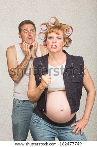 Intimidating pregnant hillbilly woman with scared husband