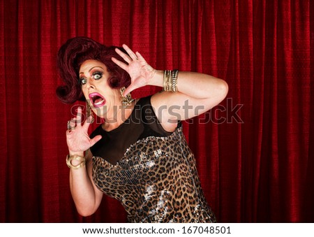 Frightened man in drag queen in theater