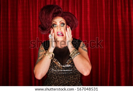 Uncertain drag queen with hands on face