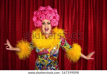 Big drag queen performing a song in theater