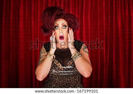 Amazed drag queen with tattoos in theater
