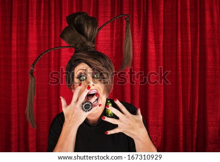 Shouting drag queen with ponytails with hands in front of mouth