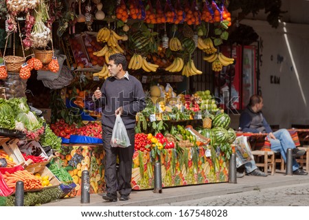 Istanbul, Turkey April 28: Man Leaves Fruit Stand With His Purchase On April 28 2012 In Istanbul, Turkey. Each Year Patriotic Turks Honor Those Fallen At The Battle Of Galipoli During World War I.