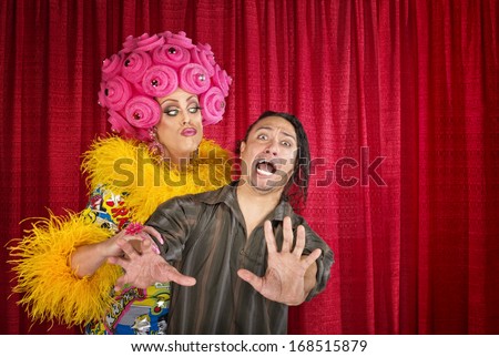 Big drag queen trying to kiss a scared man