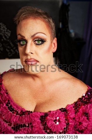 Serious drag queen without wig in dressing room