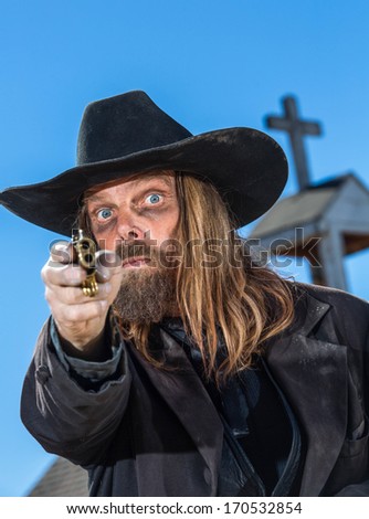 A Bandit Points Gun At Camera