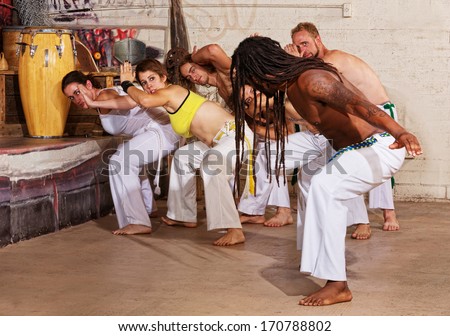 Group of capoeira students with master teacher