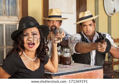 Angry 1920s vintage gangsters with weapons and whiskey