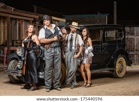 Group of male and female gangsters with guns