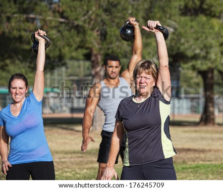 Mature white female exercising with kettle bell weights