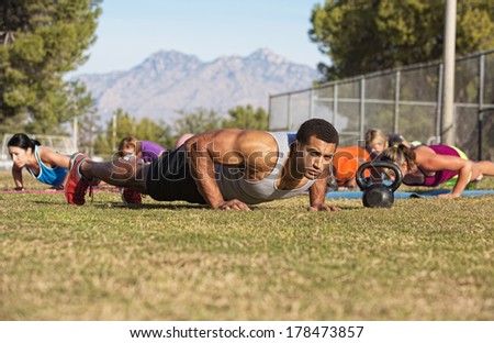 Outdoor exercise boot camp fitness group near mountain