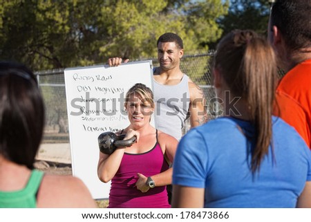 Boot camp fitness instructors explaining exercises to a class