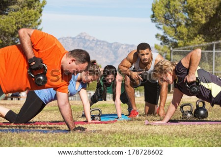 Male instructor training mature adults in boot camp fitness