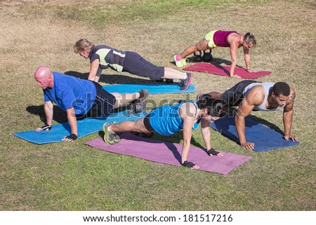 Group of five people exercising in outdoor boot camp