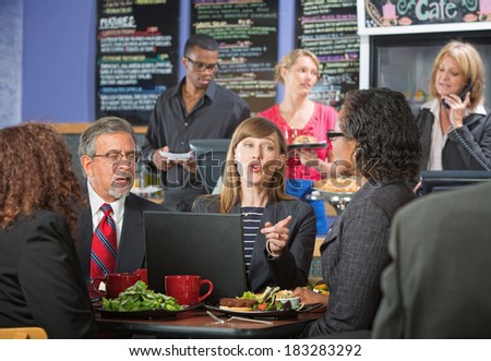 Adult business people in conversation during lunch break