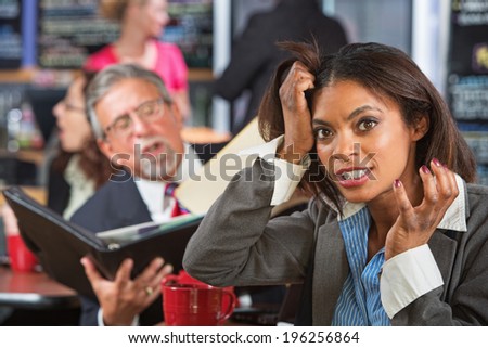 Annoying business man reading to woman pulling her hair