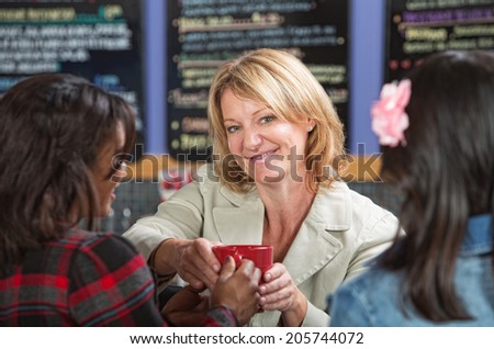 Happy restaurant manager with customers and coffee