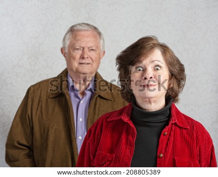 Funny senior European woman teasing confused man