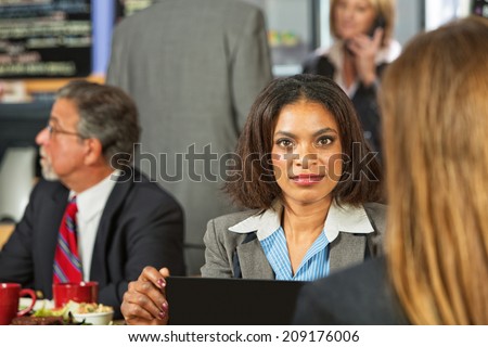 Beautiful Black business woman with laptop in cafe