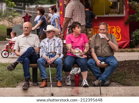 DES MOINES, IA /USA - AUGUST 10: Unidentified people enjoy food at the Iowa State Fair on August 10, 2014 in Des Moines, Iowa, USA.