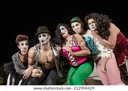 Group of crying cirque clowns on stage