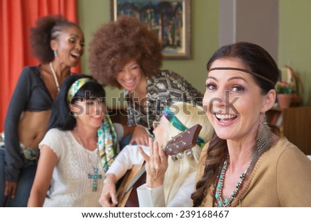 Cheerful group of five females singing 1960s folk songs