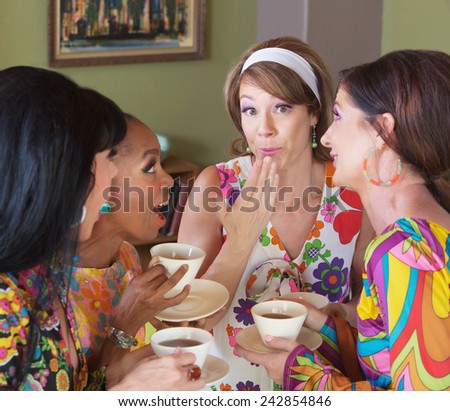 Cute European woman with hand by mouth talking with friends